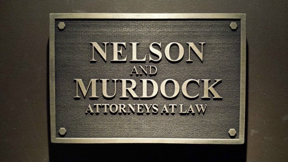 A sign in black reading: Murdock & Nelson Attorneys at Law.