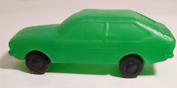 a green, plastic toy car, with black tyres.